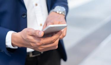 A business person using a smartphone - Empire Life Investments Inc. announces changes to certai...