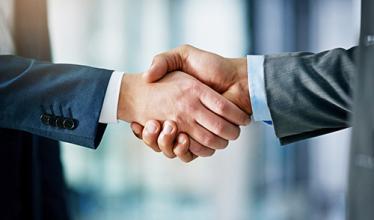 Two business people shaking hands...